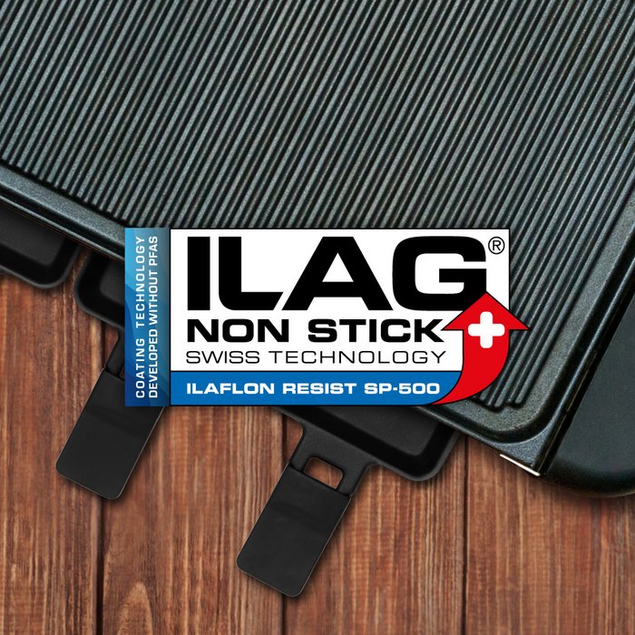 Black coated grill deflector plate from a raclette grill - ILAG logo with blue shaded Ilaflon Resist SP-500 lettering in the center and on the left hand side an extra labeling "PFAS-FREE" in blue